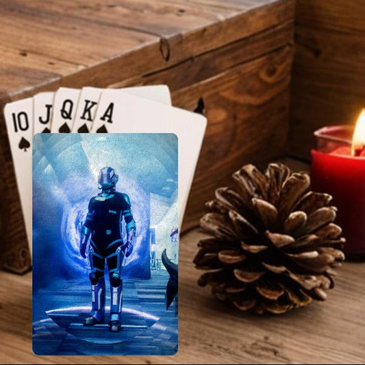 Wooden box with playing cards, a lit candle, and Christmas decorations on a wooden surface.