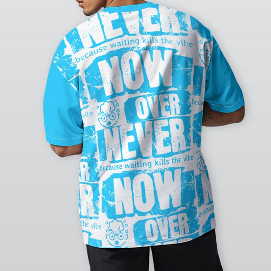 Person wearing a blue and white graphic t-shirt with text on the back, standing against a plain background.