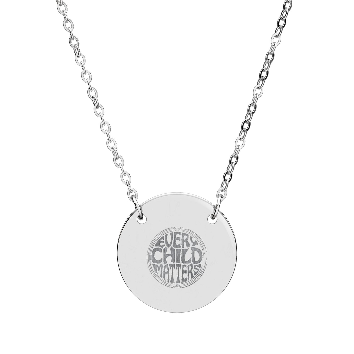 Silver necklace with a round pendant engraved with 'Every Child Matters' on a white background
