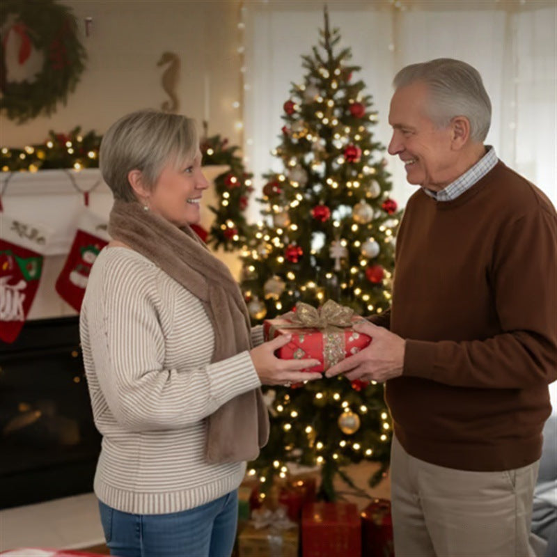 Senior couple exchanging gifts in a festive living room with Christmas decorations. Woman wearing cozy scarf.