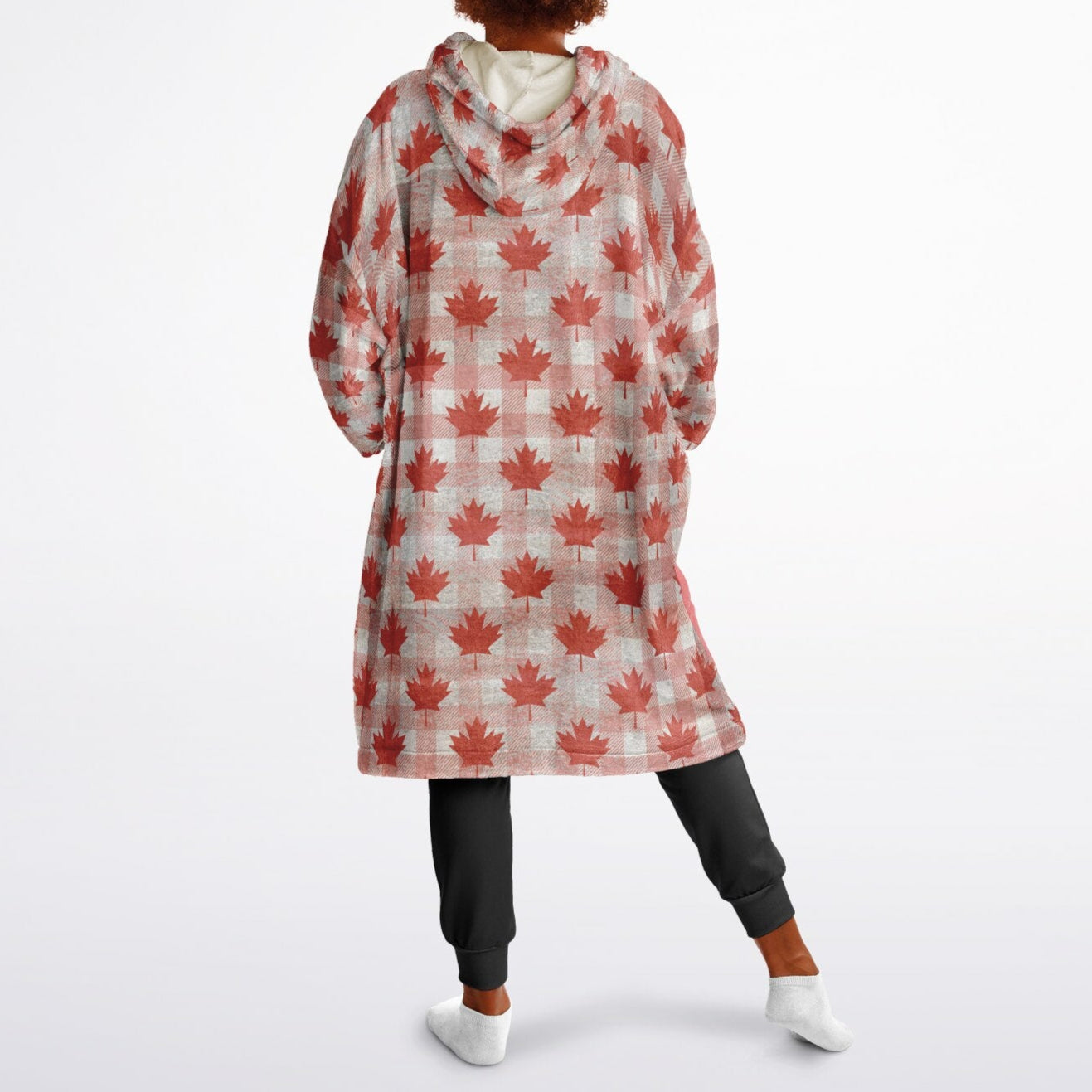Person wearing a red maple leaf patterned oversized hoodie 
on a white background