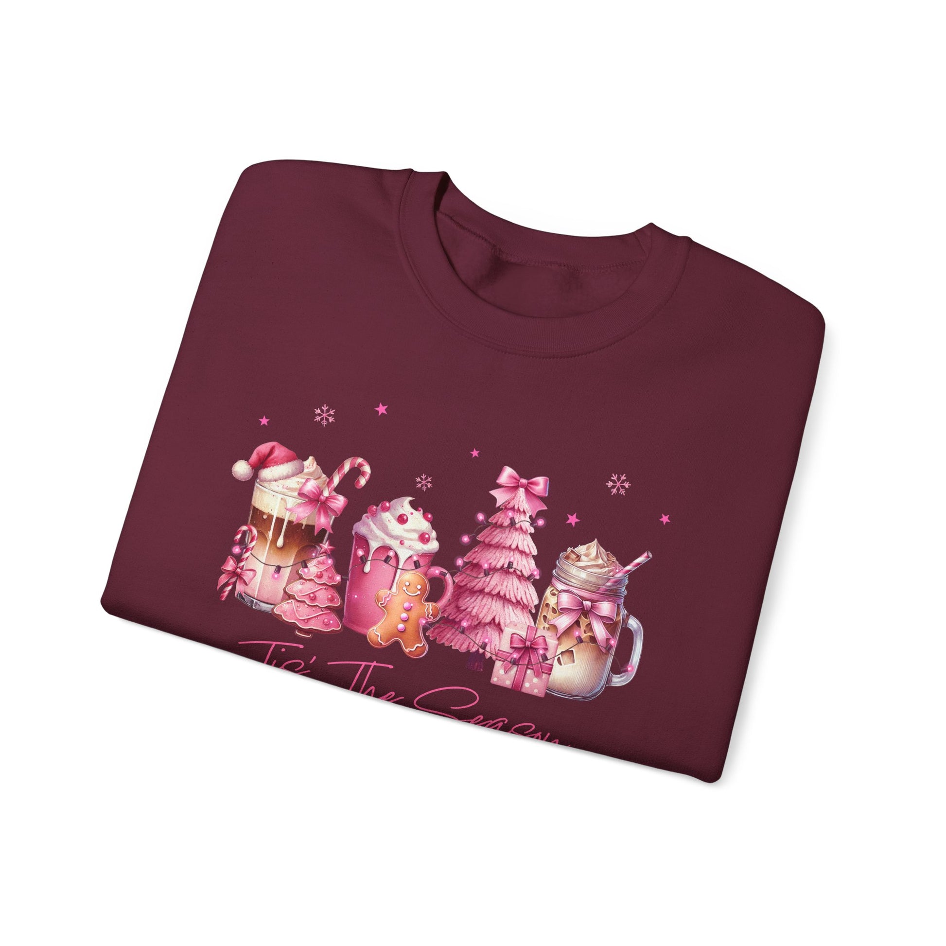 Folded maroon sweatshirt with Christmas-themed design on a white background