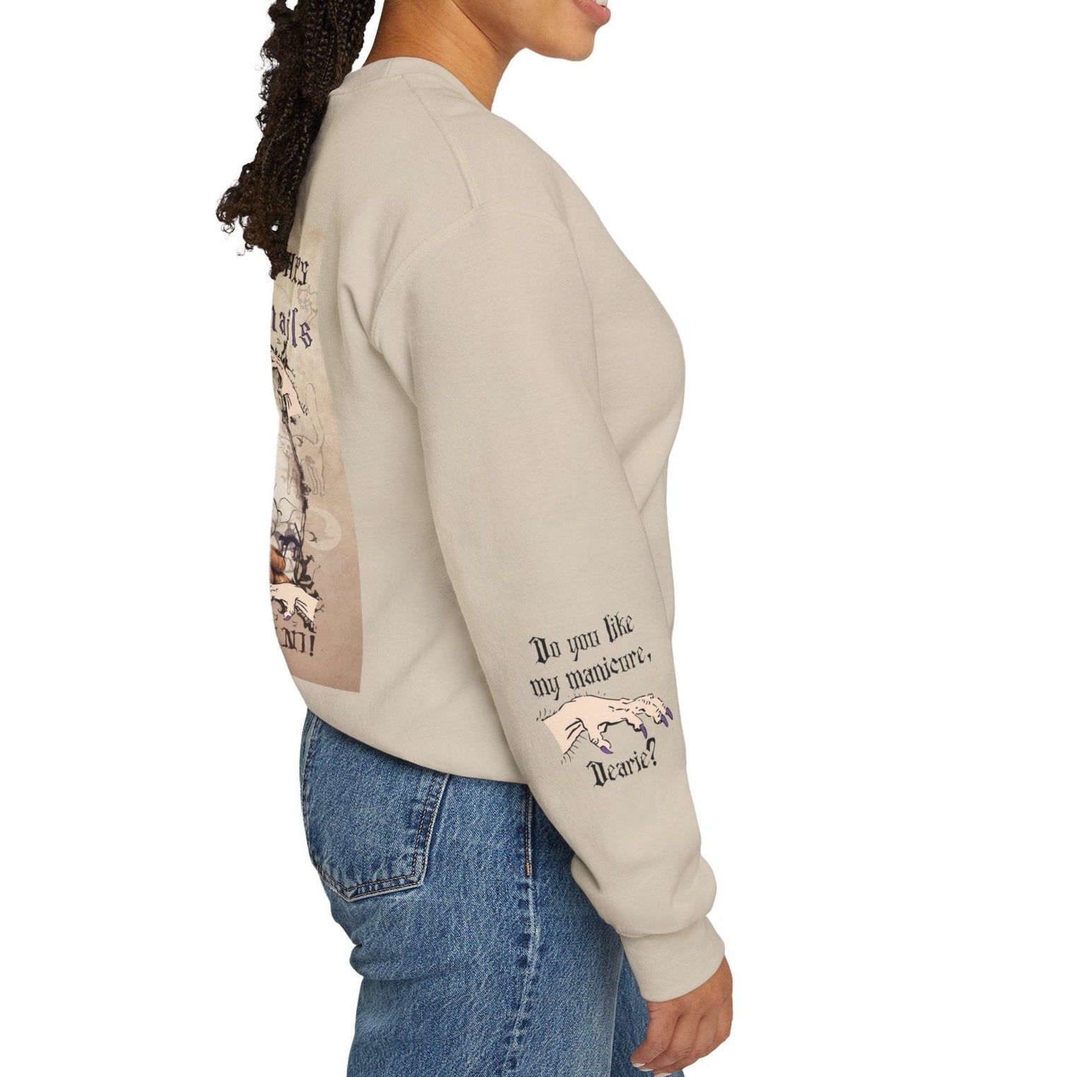 Woman wearing a beige sweatshirt with text and graphics, standing against a white background