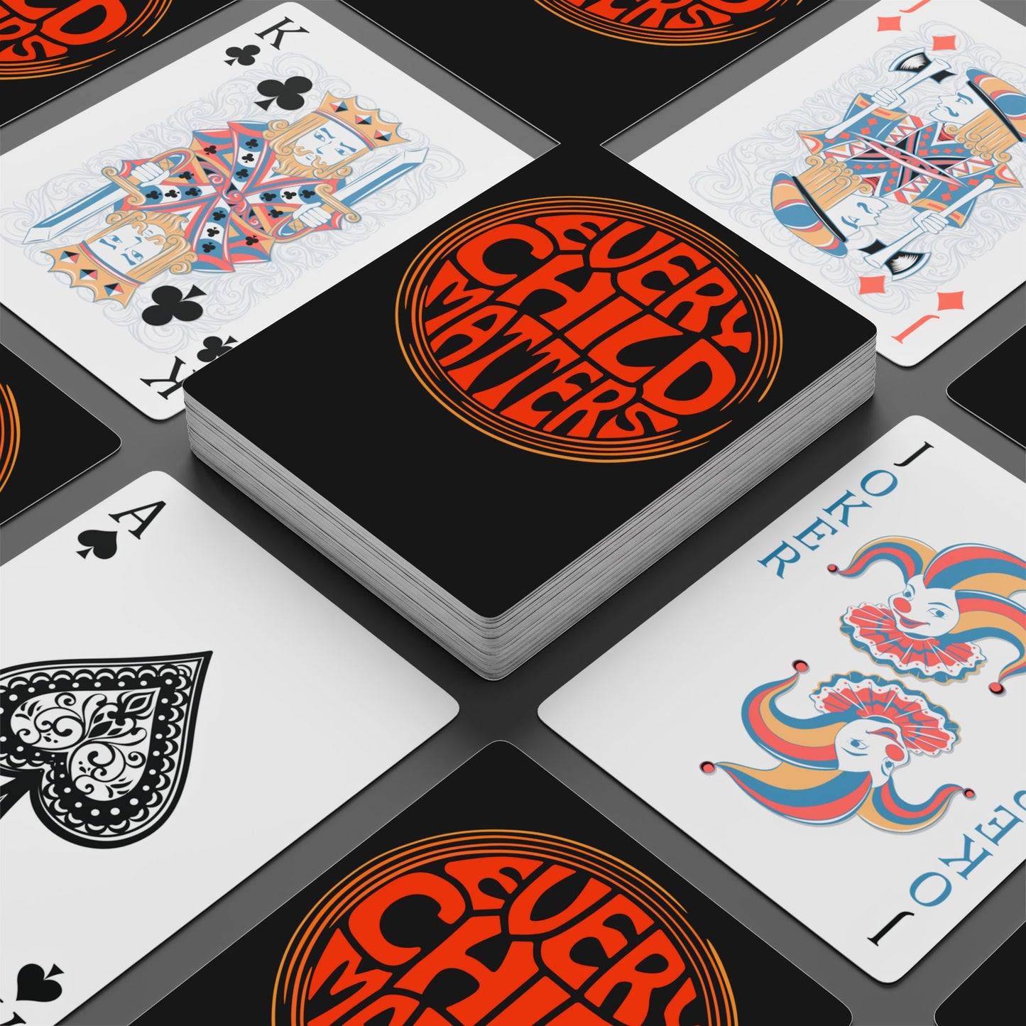 Playing cards with 'Every Child Matters' logo on a black card