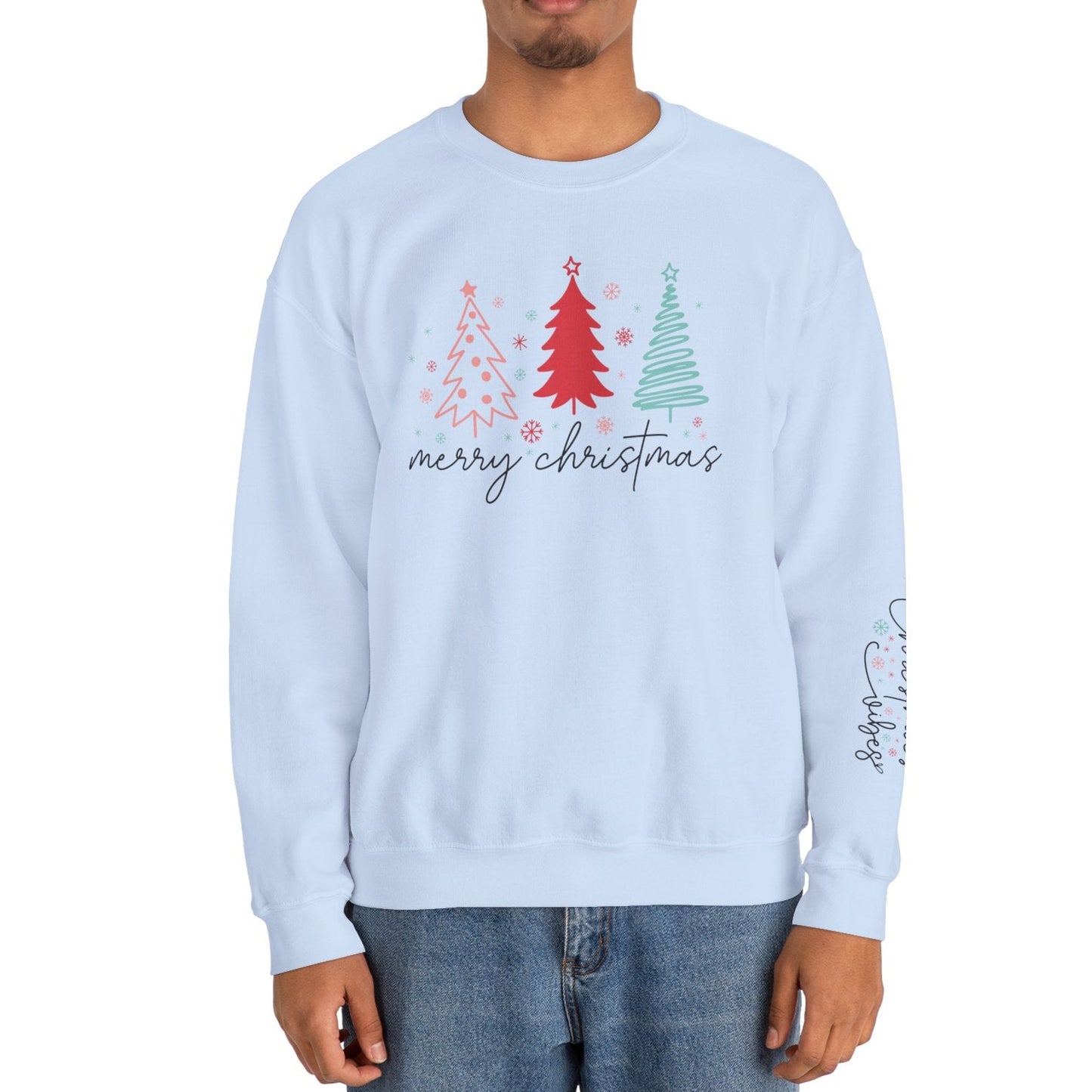 Person wearing a light blue sweatshirt with Christmas tree design and 'Merry Christmas' text on a white background