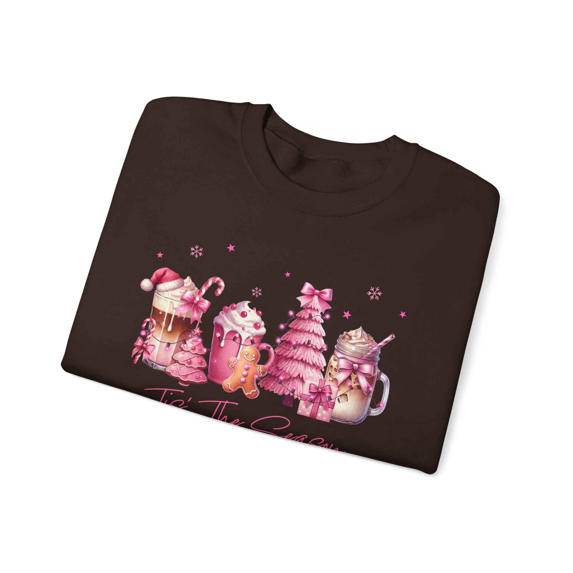 Folded brown sweatshirt with Christmas-themed graphics on a white background