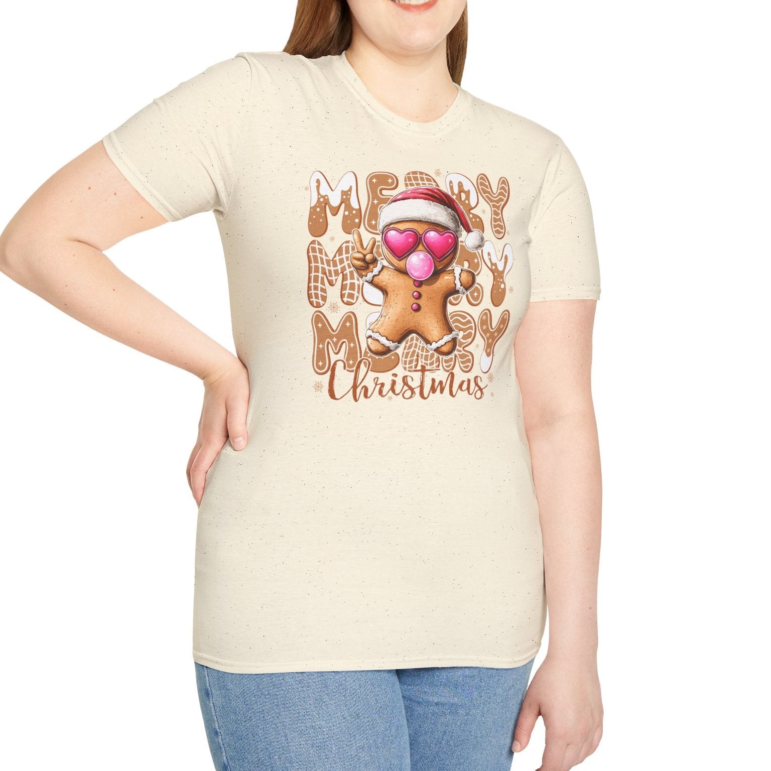 Woman wearing a cream t-shirt with a gingerbread man and 'Merry Masy Christmas' text design.