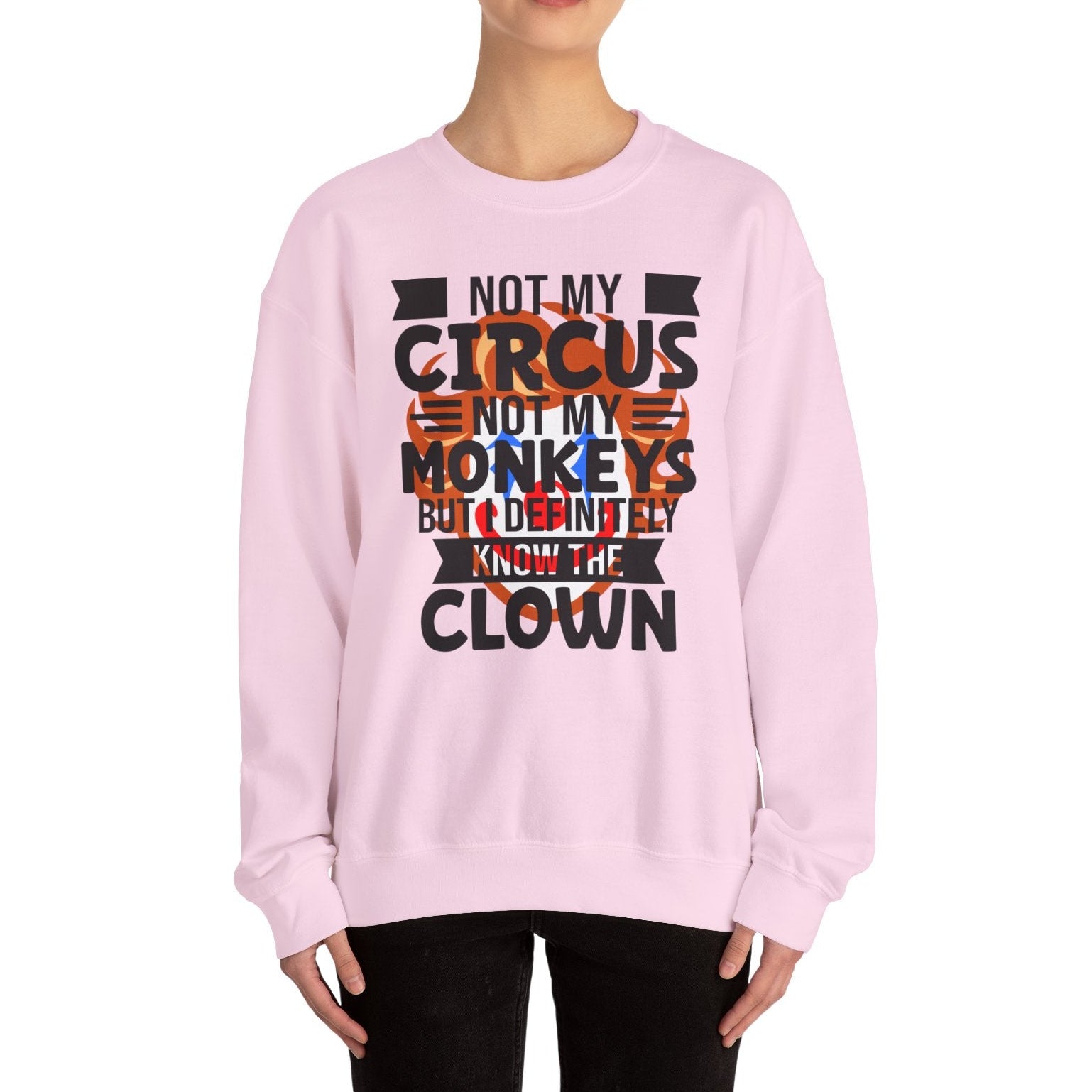 Person wearing a pink sweatshirt with a colorful text design on a white background