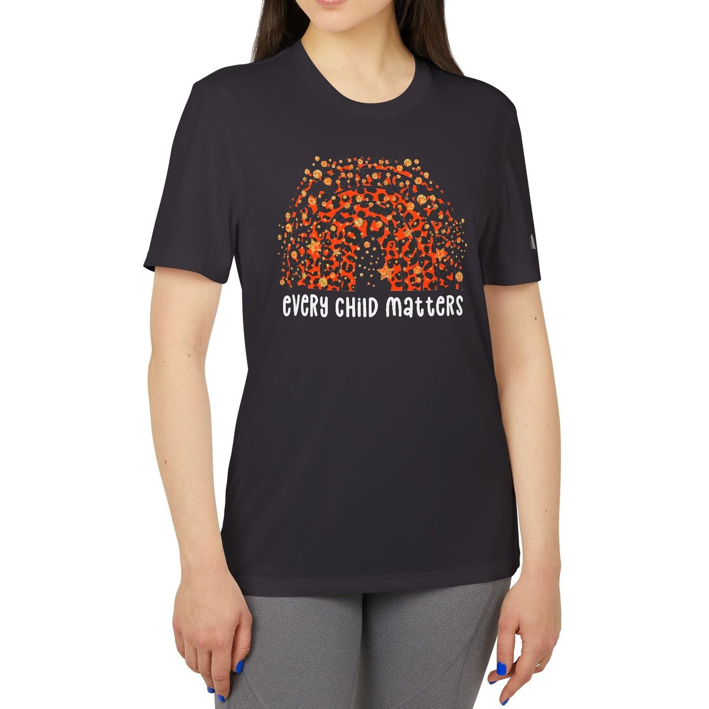 Woman wearing a black t-shirt with an orange and white graphic and text on a white background