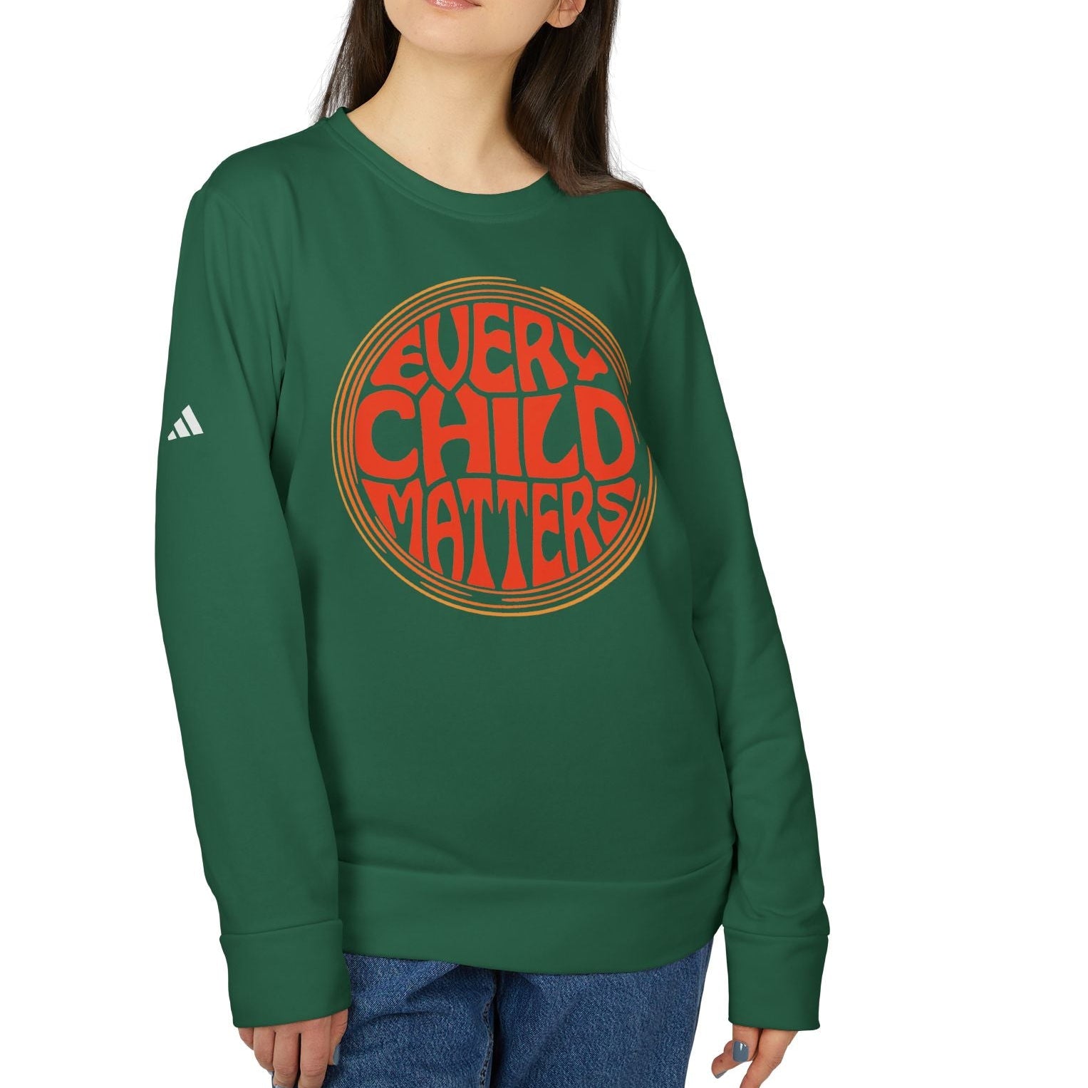 Person wearing a green sweatshirt with 'Every Child Matters' text on a white background