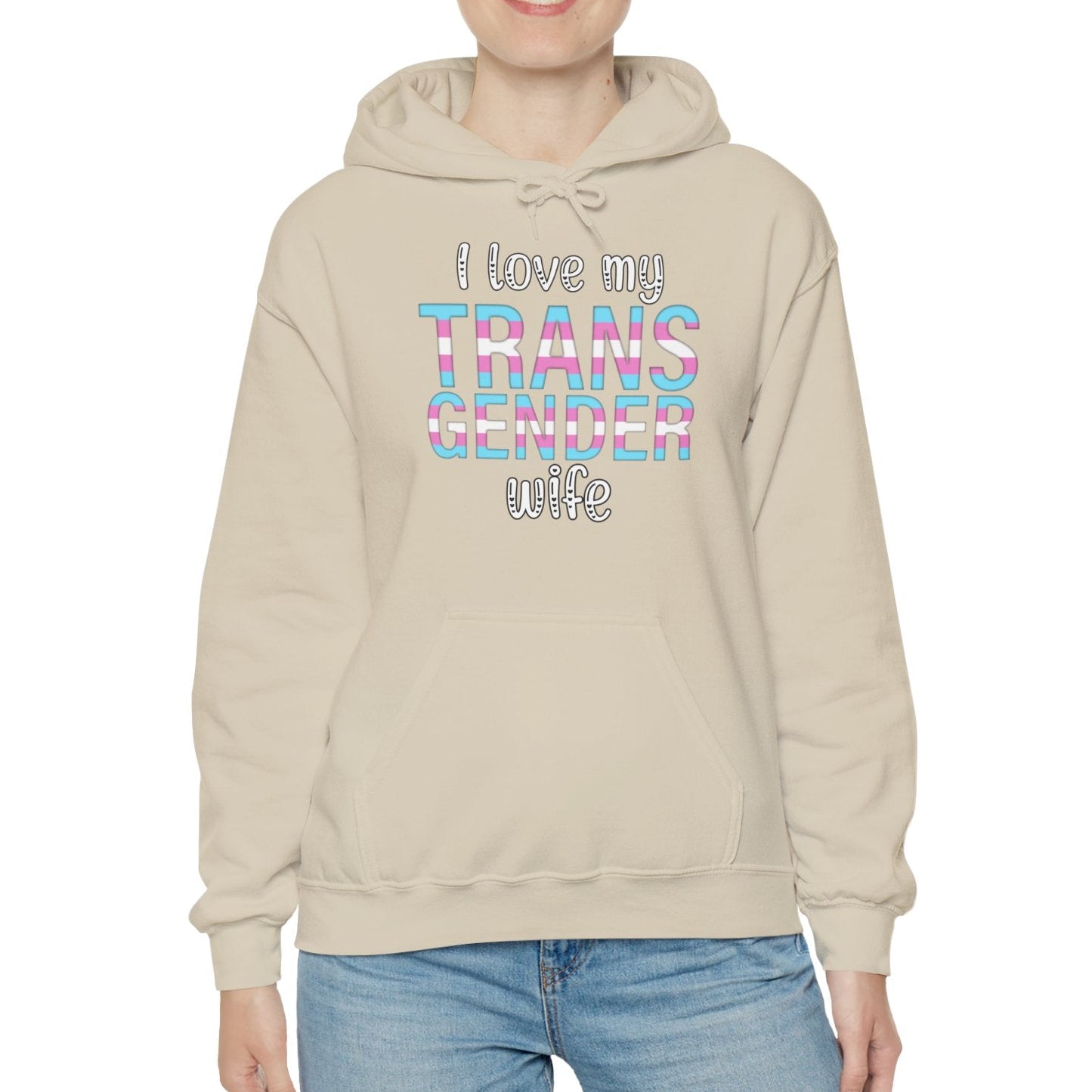 Person wearing a beige hoodie with colorful text on a white background