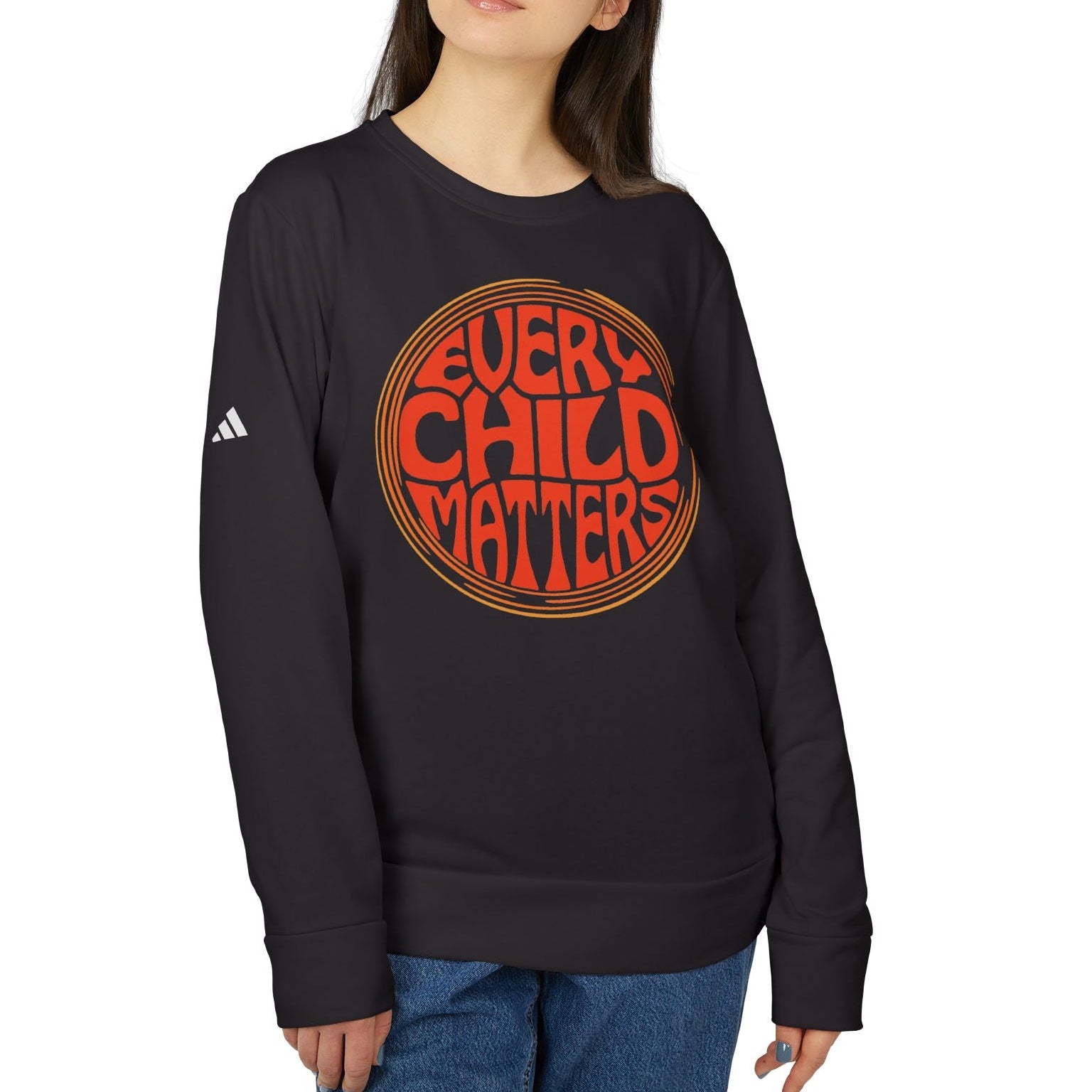 Person wearing a black sweatshirt with 'Every Child Matters' text on a white background