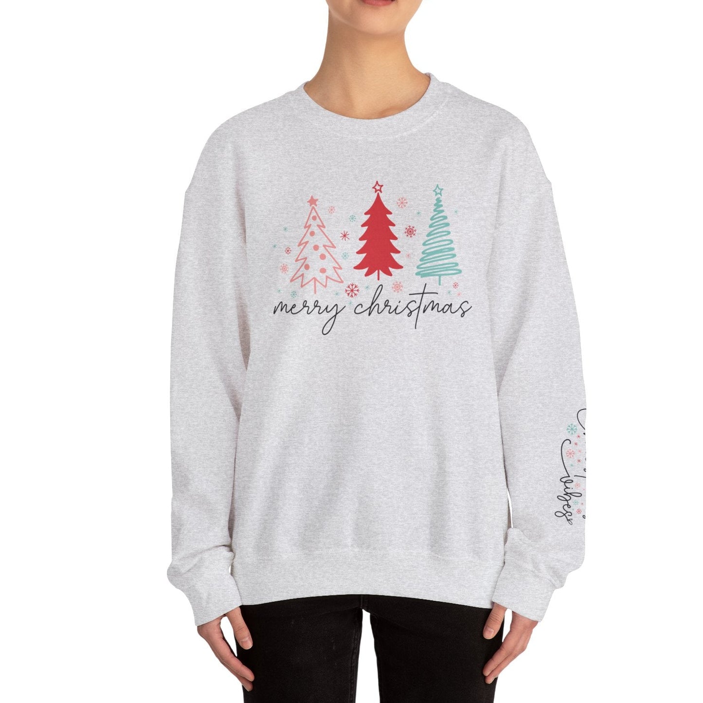 Person wearing a gray sweatshirt with Christmas tree design and 'merry christmas' text on a white background
