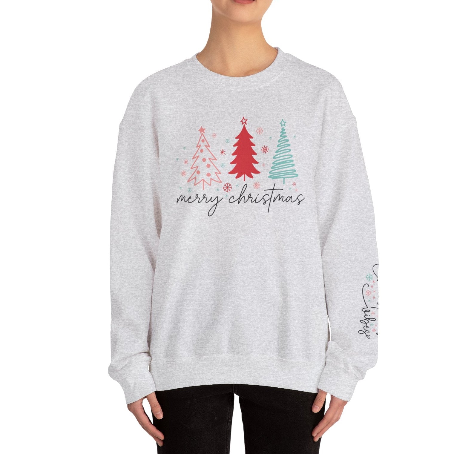 Person wearing a gray sweatshirt with Christmas tree design and 'merry christmas' text on a white background