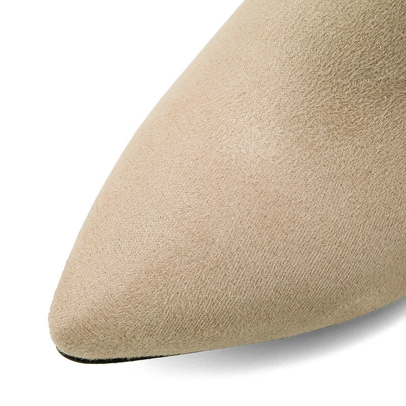 Close-up of a beige shoe toe on a white background