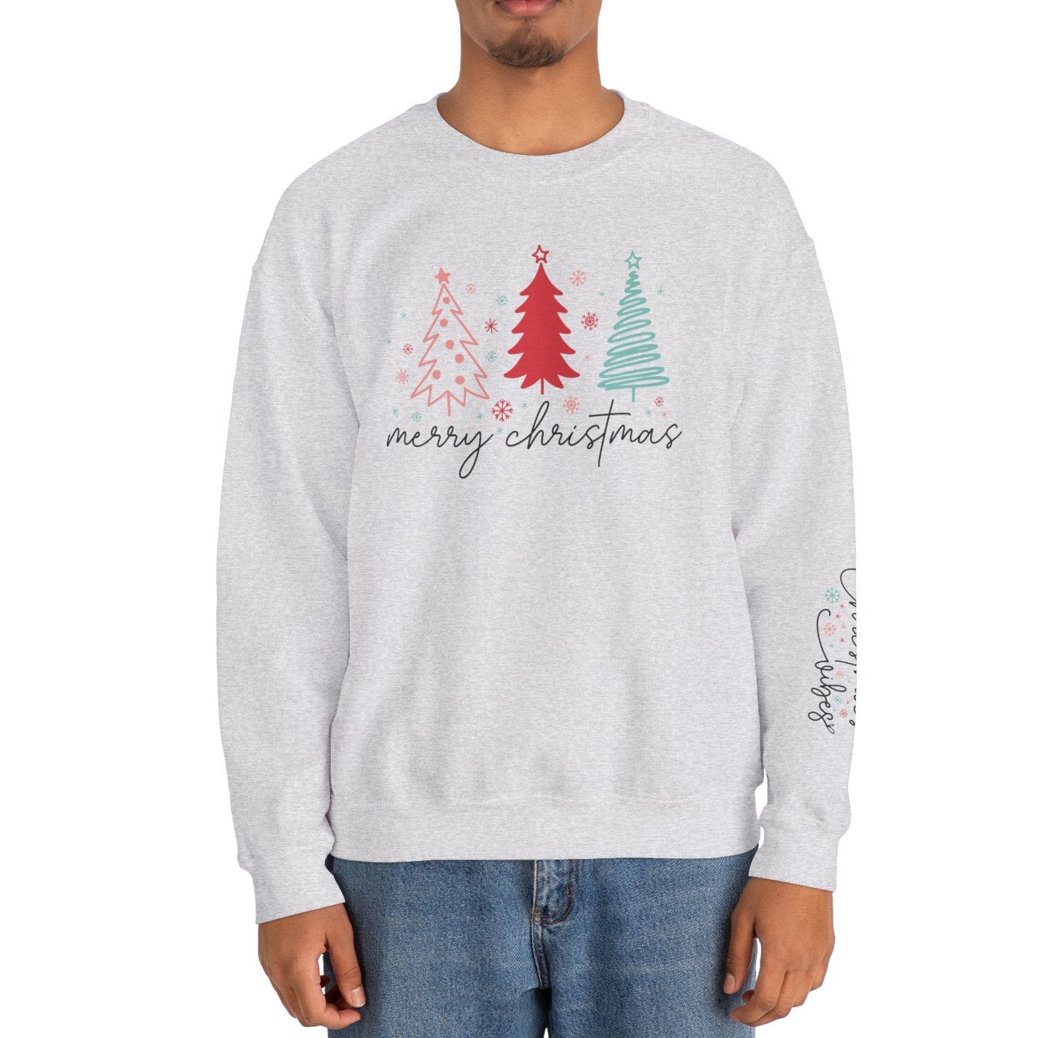 Person wearing a light gray sweatshirt with Christmas tree design and 'Merry Christmas' text on a white background