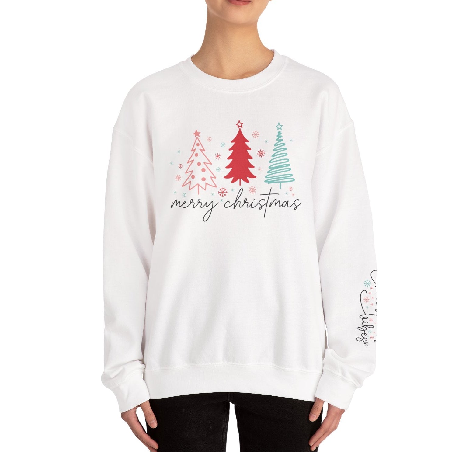 White sweatshirt with Christmas tree design and 'merry christmas' text worn by a person on a white background