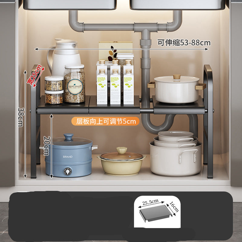 Under-sink kitchen organizer with pots, bowls, and bottles on a neutral background