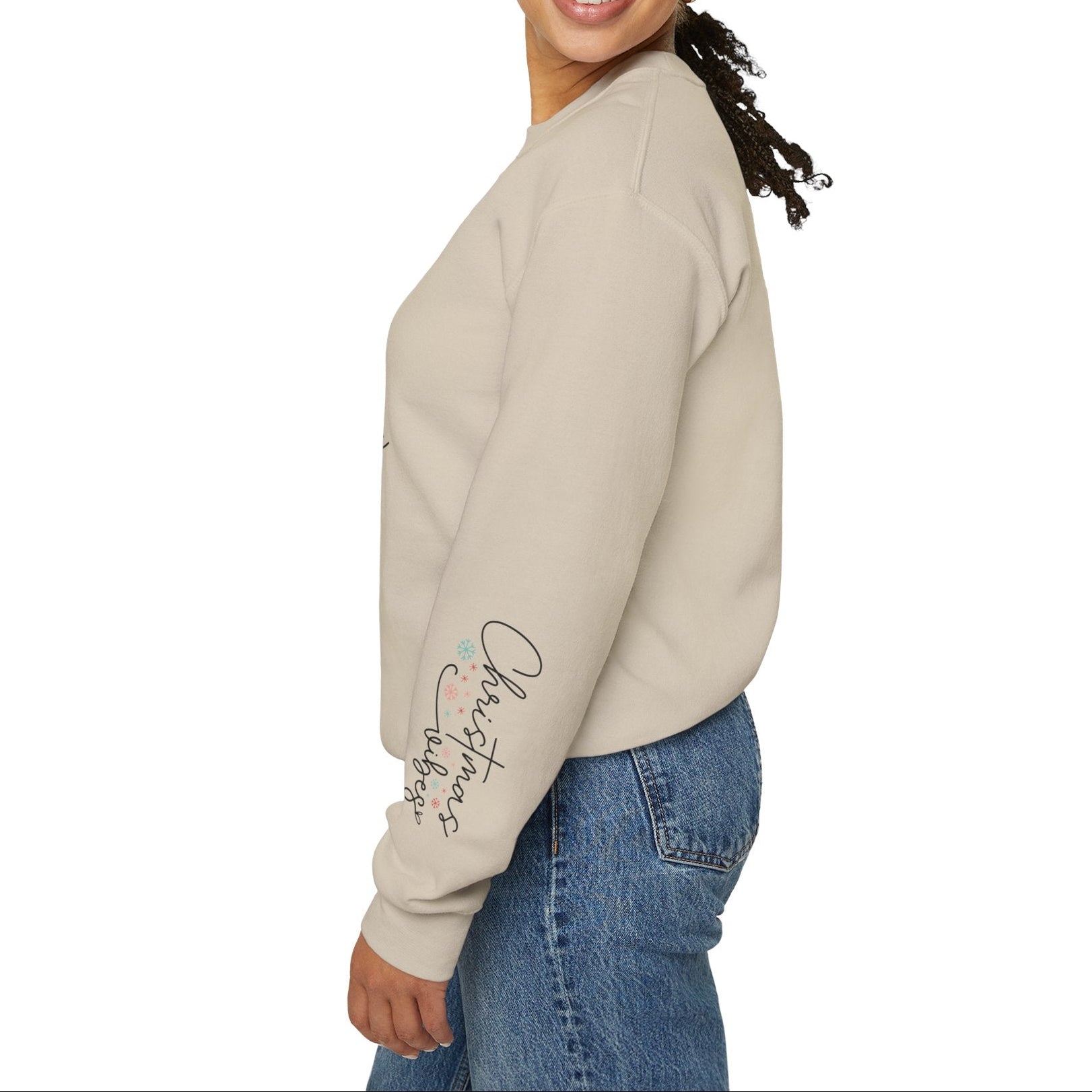 Woman wearing a beige sweatshirt with text on the sleeve against a white background