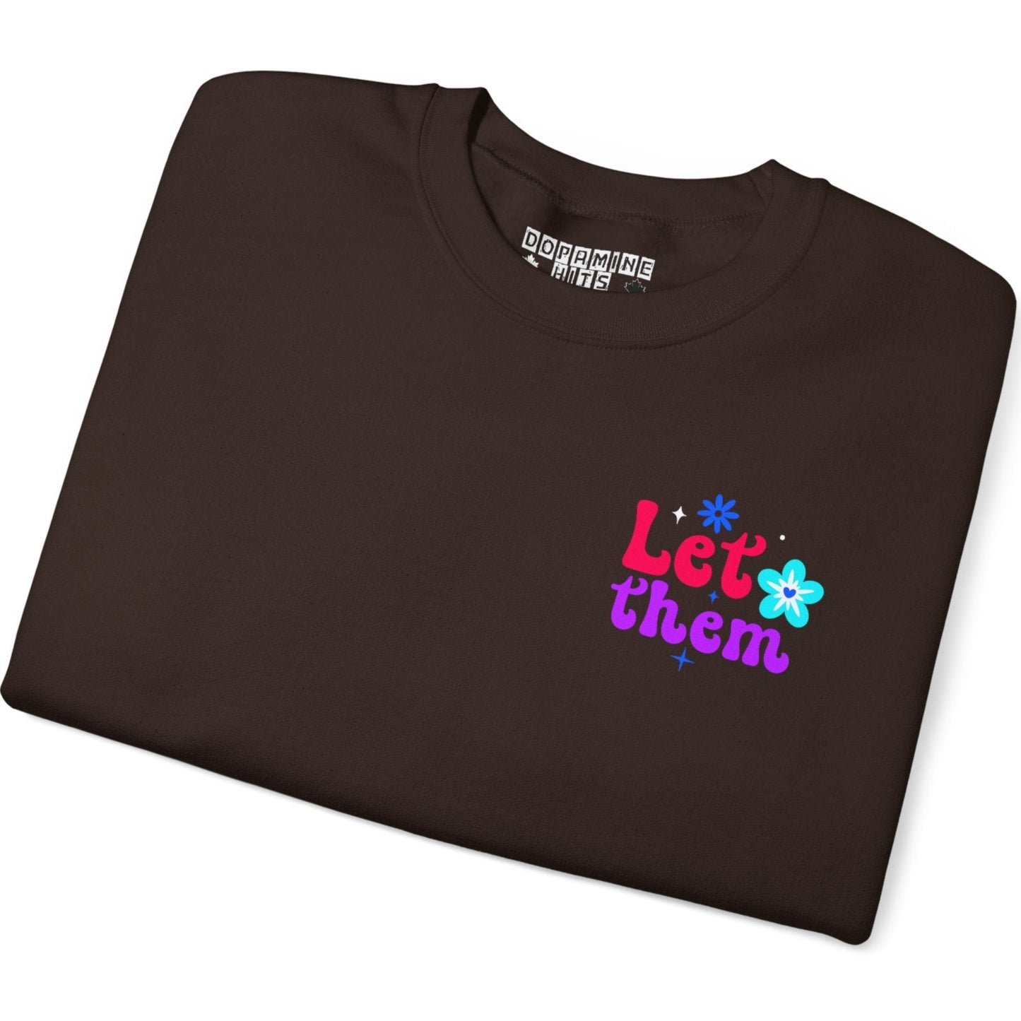 Folded brown t-shirt with colorful text and graphics on a white background