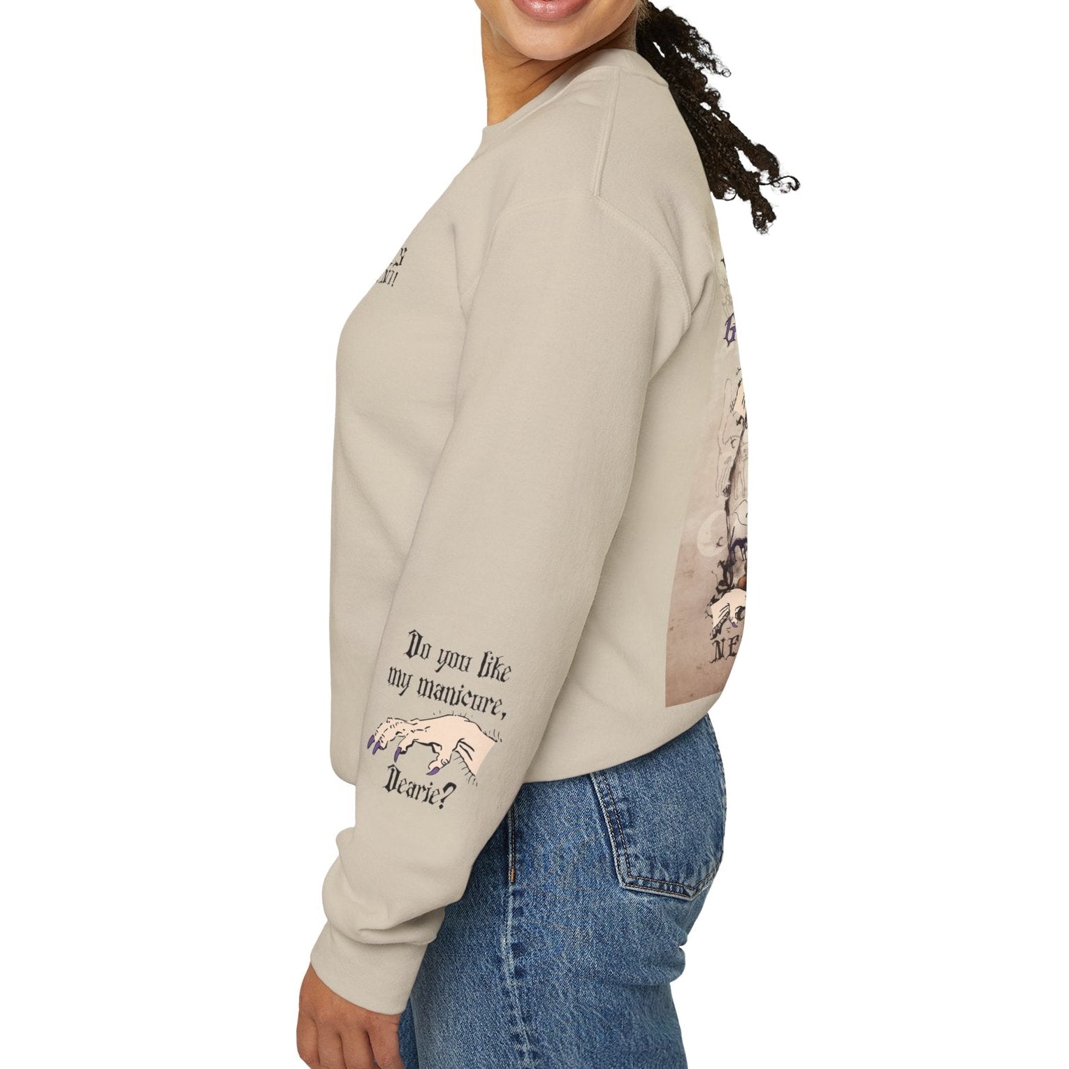Woman wearing a beige sweatshirt with text and graphics, standing against a white background