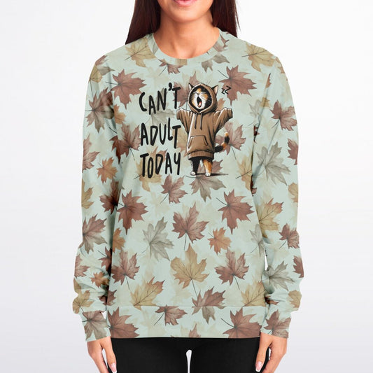 Woman wearing a sweatshirt with a cat graphic and text on a light green background