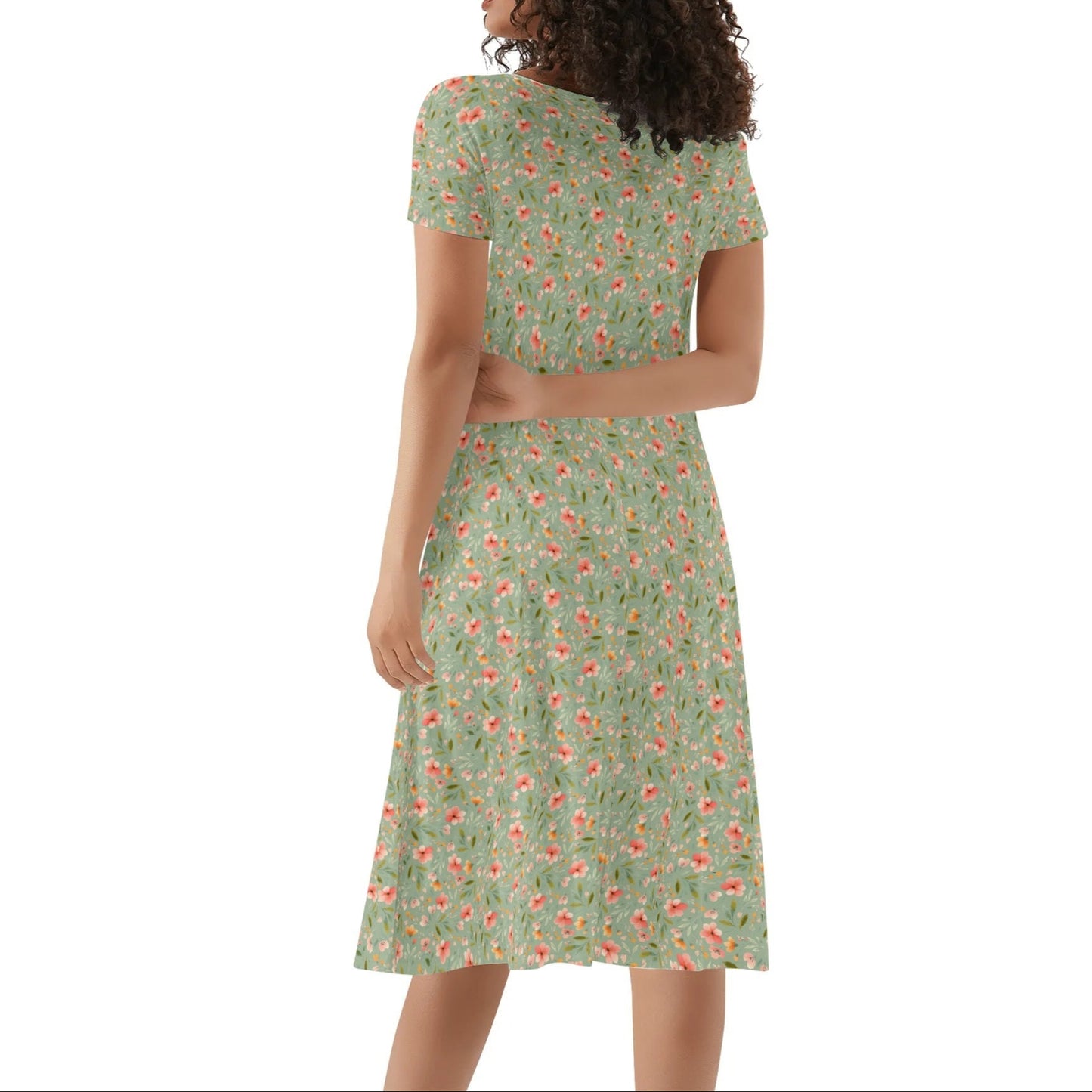 Woman wearing a green floral dress on a white background