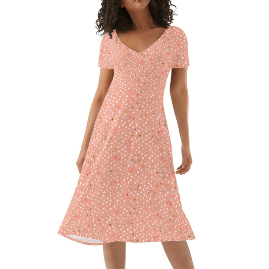 Woman wearing a peach floral dress on a white background