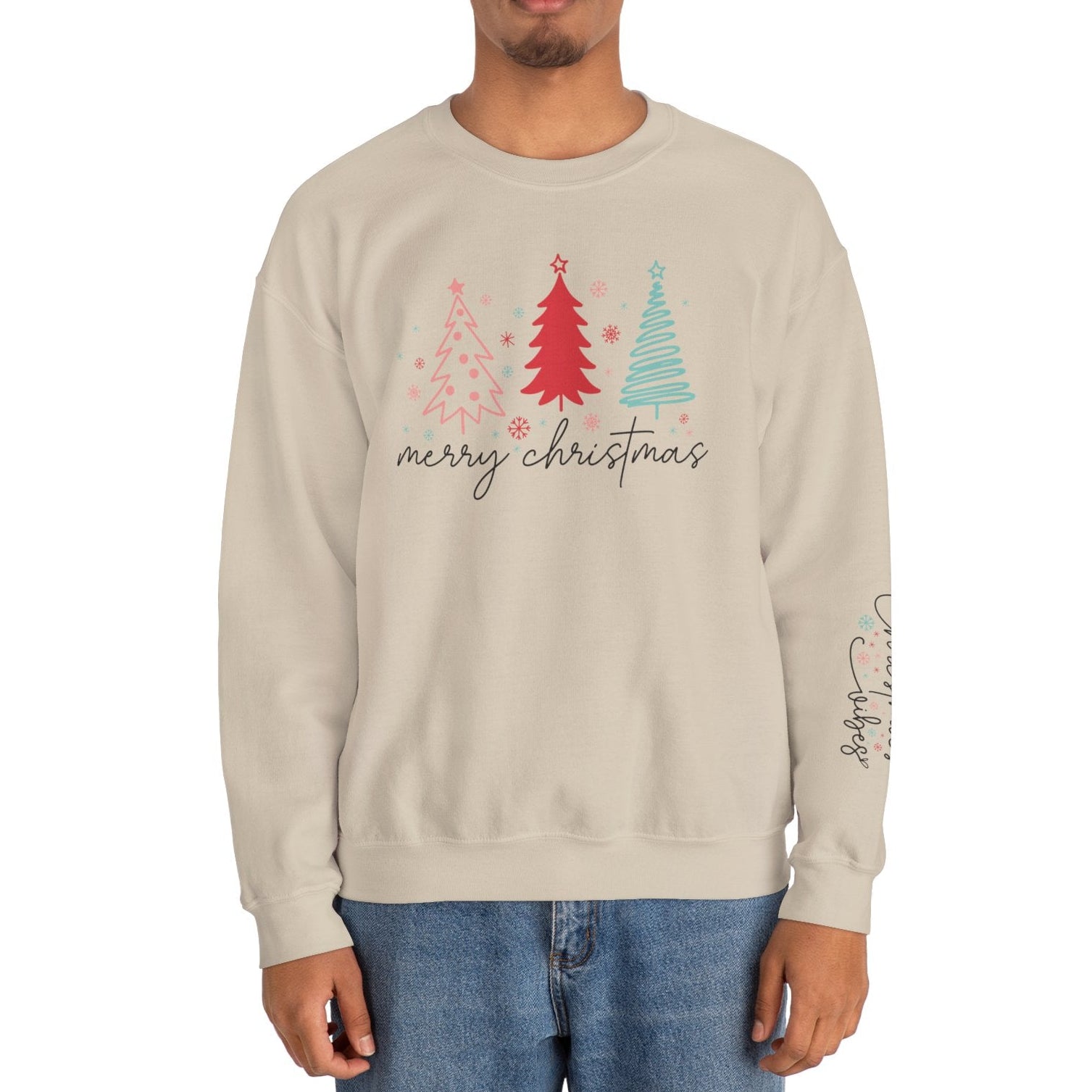 Person wearing a beige sweatshirt with Christmas tree design and 'merry christmas' text on a white background