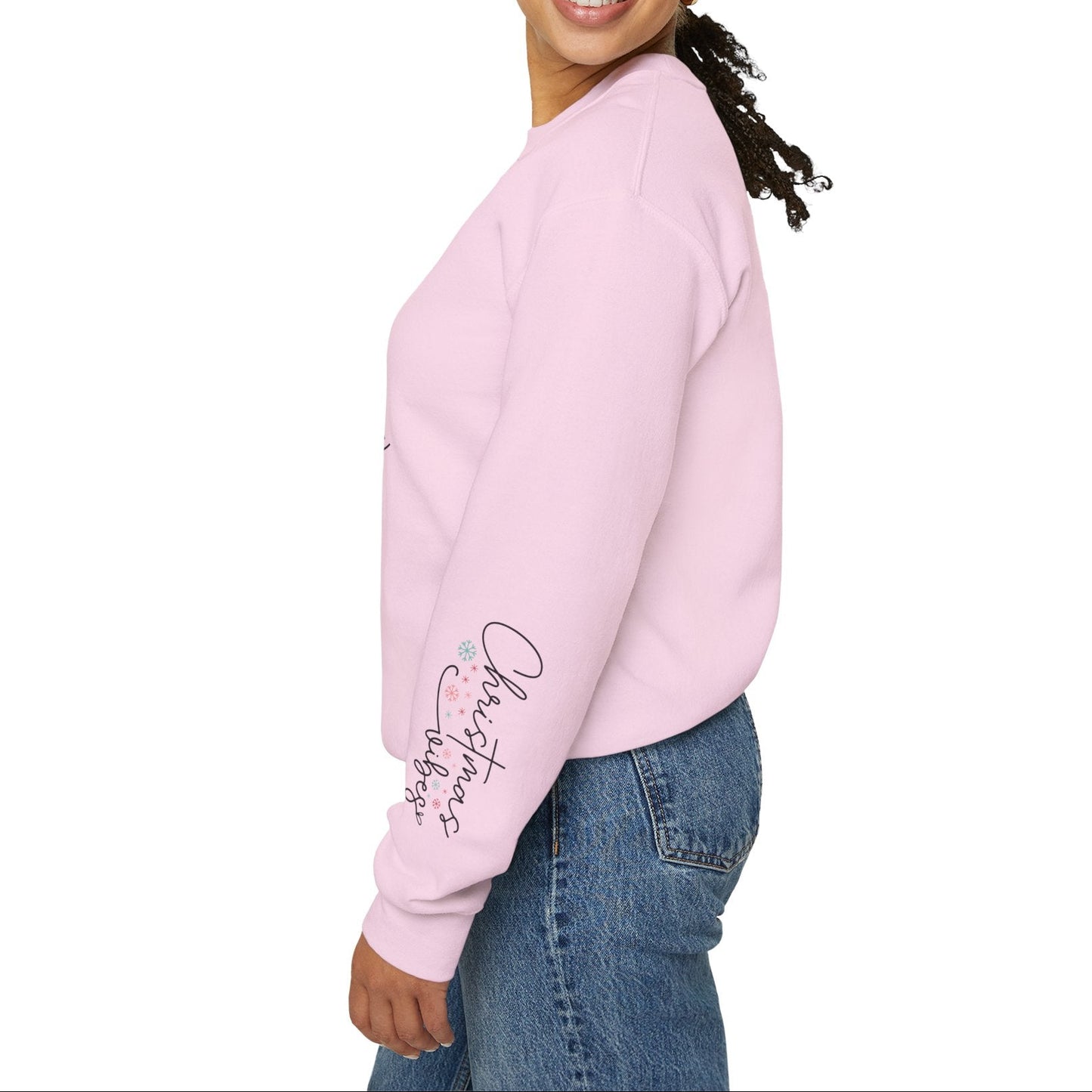 Woman wearing a light pink sweatshirt with text on the sleeve against a white background