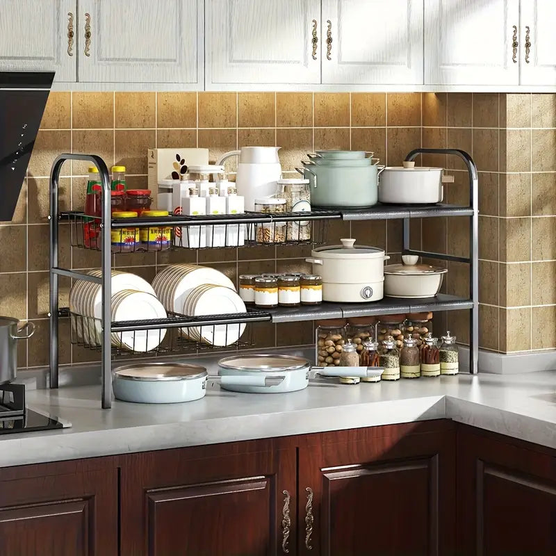 Kitchen with a dish rack holding various dishes and a tiled wall.