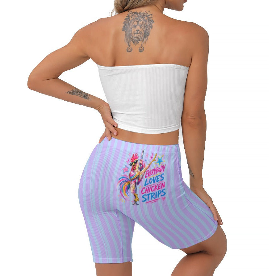 A woman shown from the back wearing light purple and blue striped biker shorts with a colourful chicken graphic and the text 'EVERYBODY LOVES CHICKEN STRIPS' on the back, paired with a white strapless crop top against a plain white background.