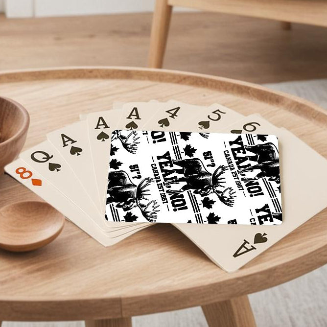 Round wooden table with a bowl of lemons, wooden spoon, and playing cards in a living room setting.