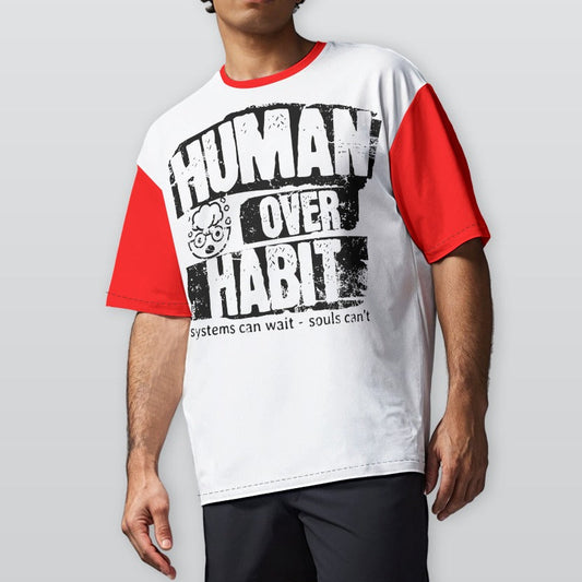 Person wearing a white and red t-shirt with 'Human Over Habit' text on a plain background