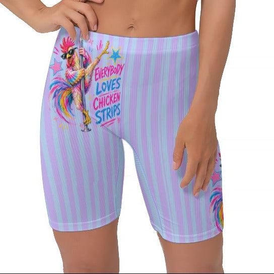 A woman modeling light blue and purple vertically striped biker shorts with a colourful cartoon graphic and the text 'EVERYBODY LOVES CHICKEN STRIPS'.