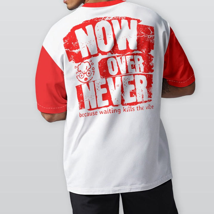 Person wearing a white and red t-shirt with text on the back, standing against a plain background