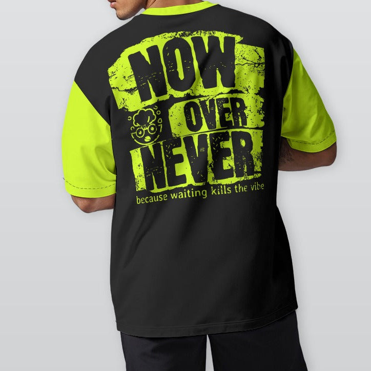 Person wearing a black and neon yellow t-shirt with text on the back, standing against a plain background