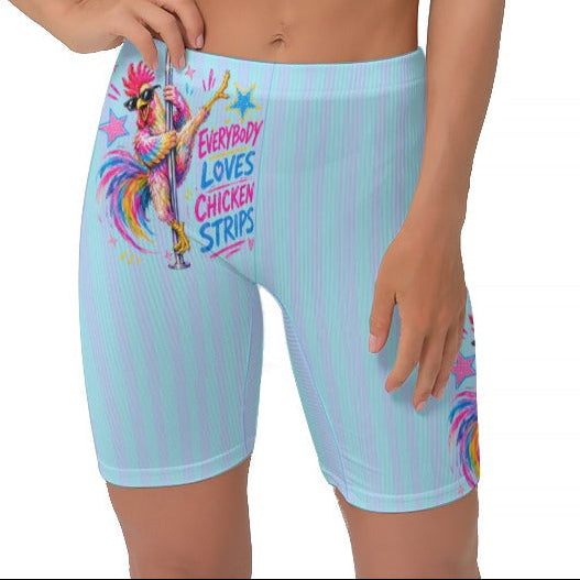 A woman modeling light blue and cyan vertically striped biker shorts with a colourful cartoon graphic and the text 'EVERYBODY LOVES CHICKEN STRIPS'.