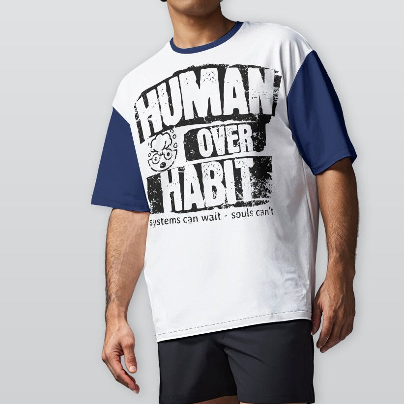 Person wearing a white and blue t-shirt with 'Human Over Habit' text on a plain background