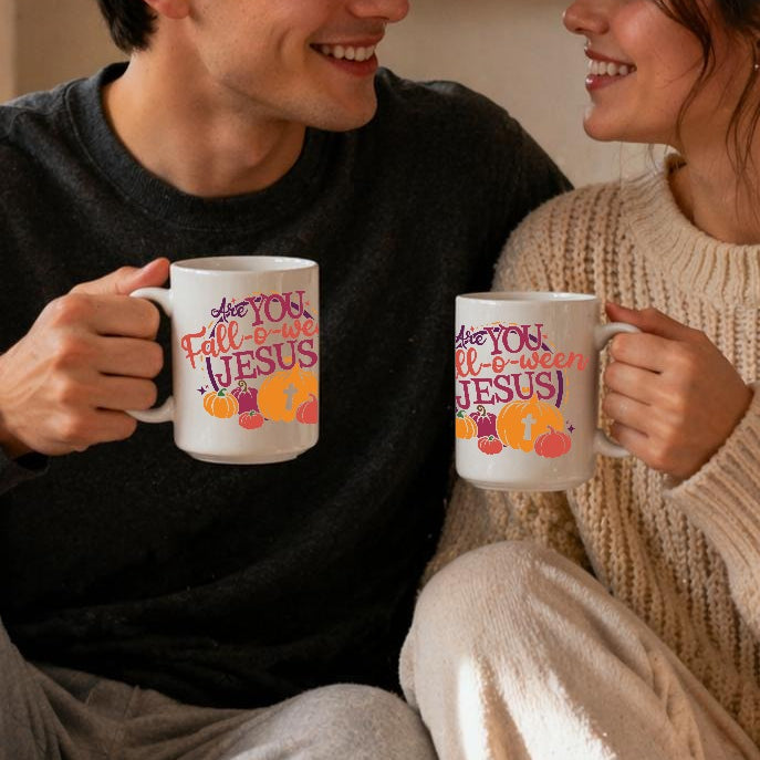 Two people sitting together holding mugs with a cozy indoor setting.