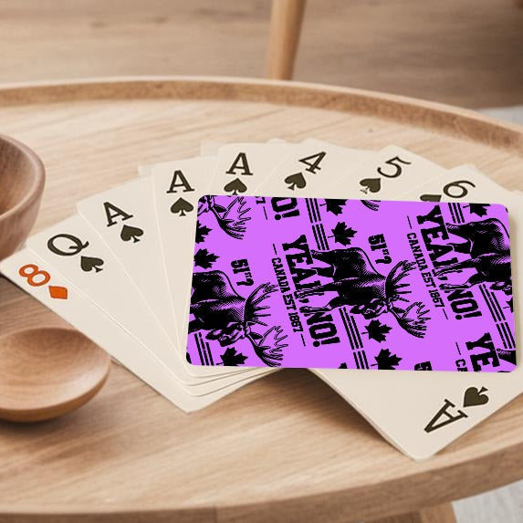 Round wooden coffee table with a bowl of lemons, a wooden spoon, and playing cards in a living room.