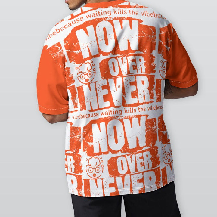 Person wearing an orange and white graphic t-shirt with text on a plain background