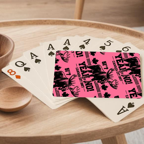 Wooden coffee table with a bowl of lemons, wooden spoon, and playing cards in a living room.