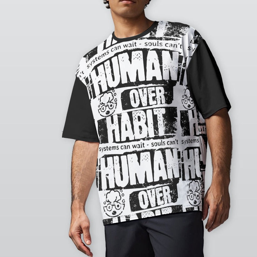 Person wearing a black and white graphic t-shirt with text on a plain background