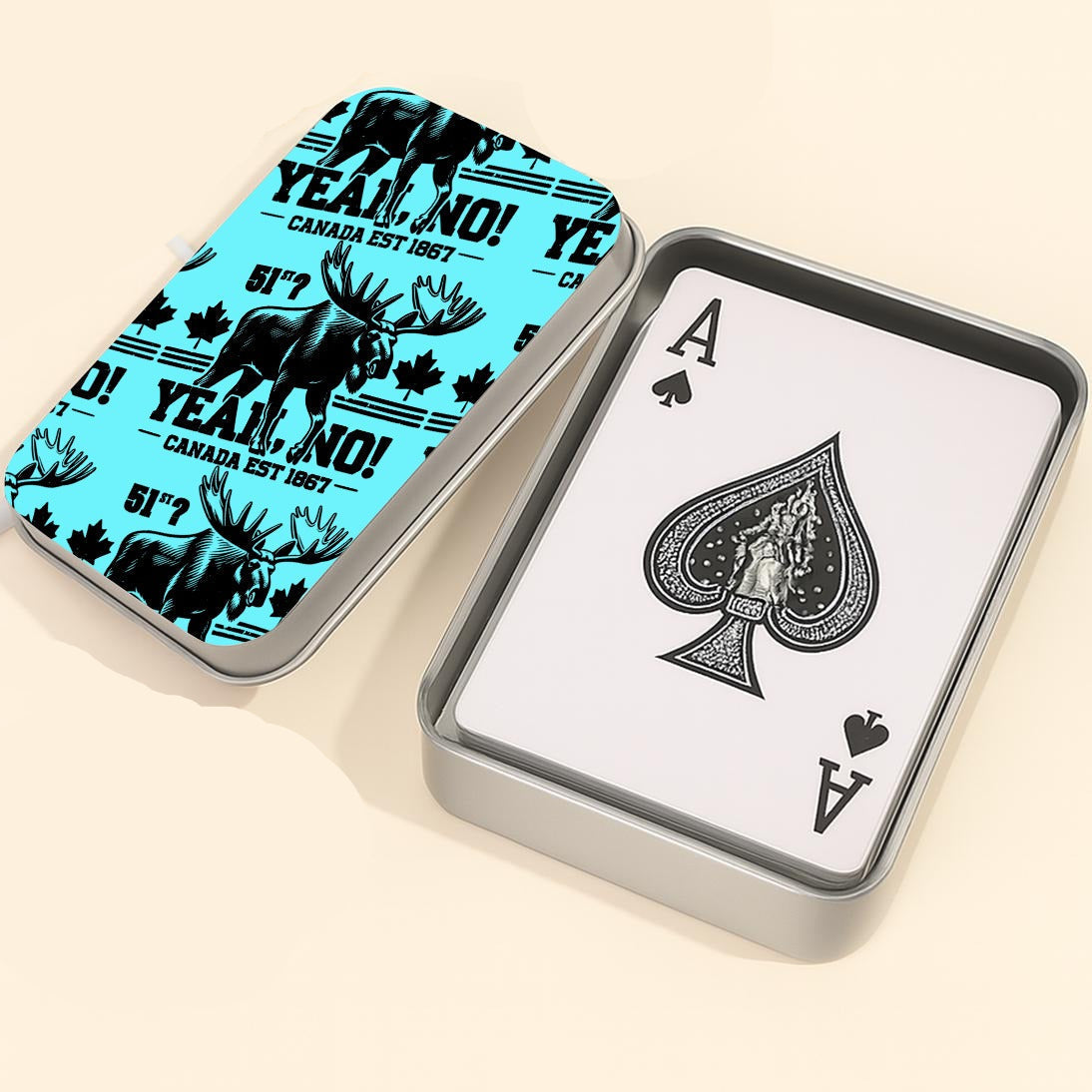 Playing card set with a blue case featuring a moose design, an Ace of Spades card, and a dice on a light background.