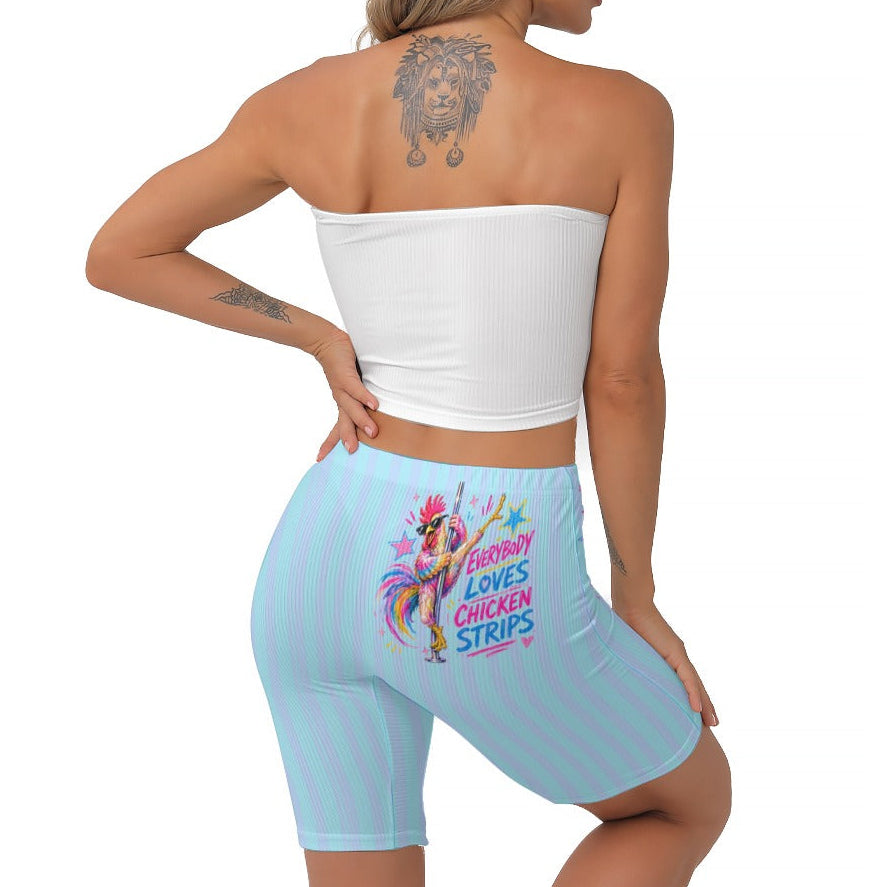 A woman shown from the back wearing light blue & cyan biker shorts with a colourful graphic and text on the back, paired with a white strapless crop top, against a plain white background.