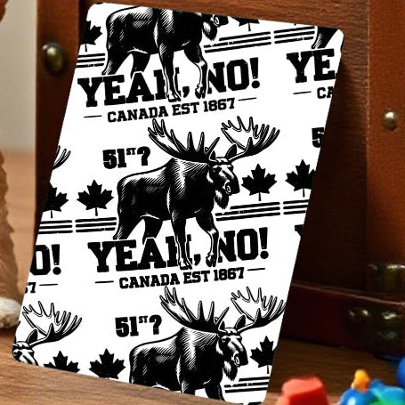 Small toy dog sitting on a table with toys and a wooden box in the background