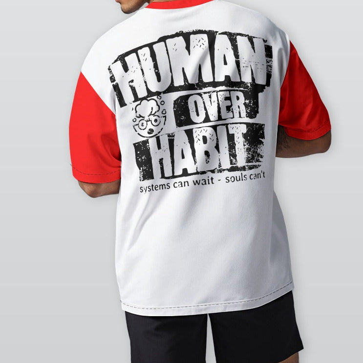Person wearing a white and red shirt with 'Human Over Habit' text on the back, standing against a plain background.