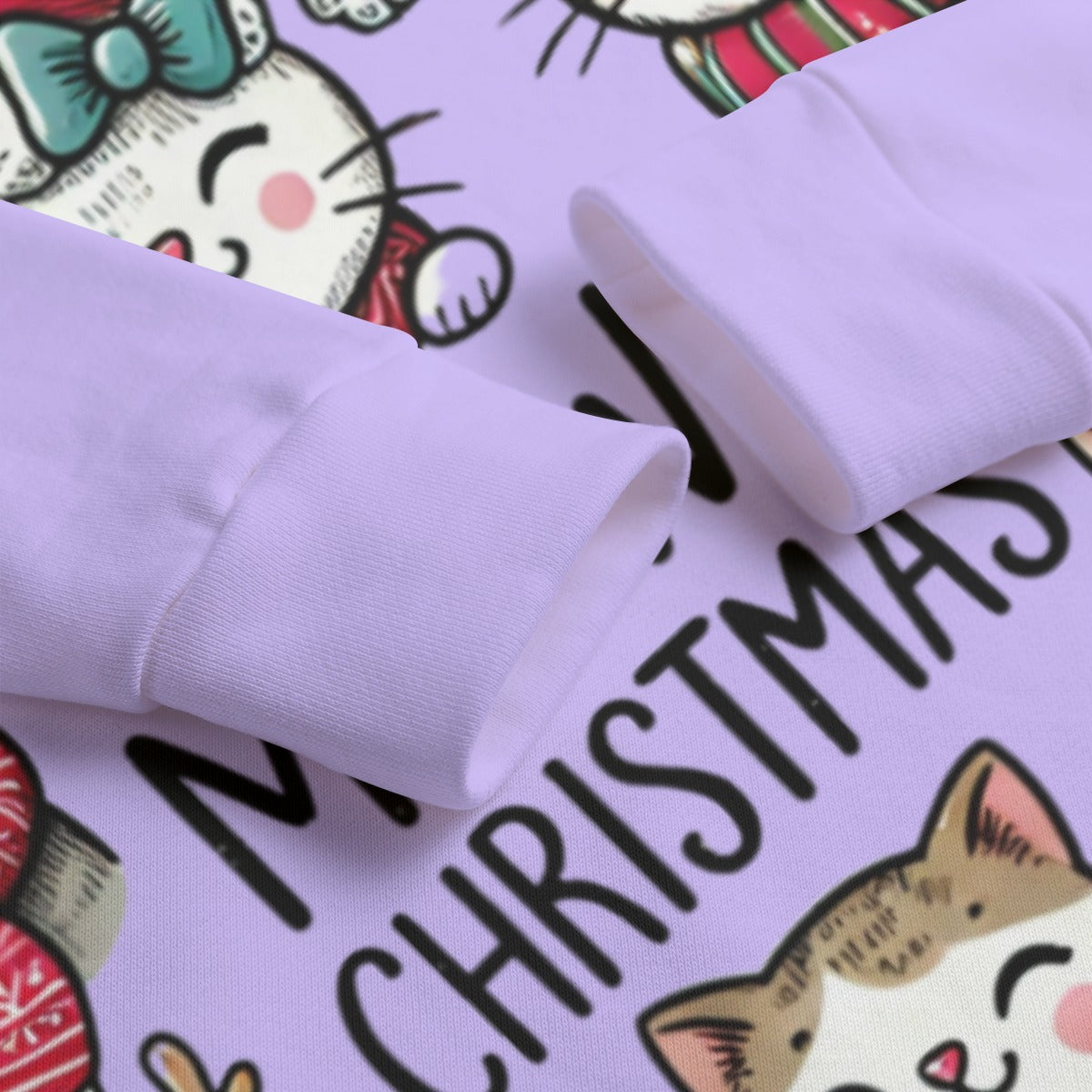 Close-up of a purple sweatshirt with cartoon cat designs and 'Merry Christmas' text.