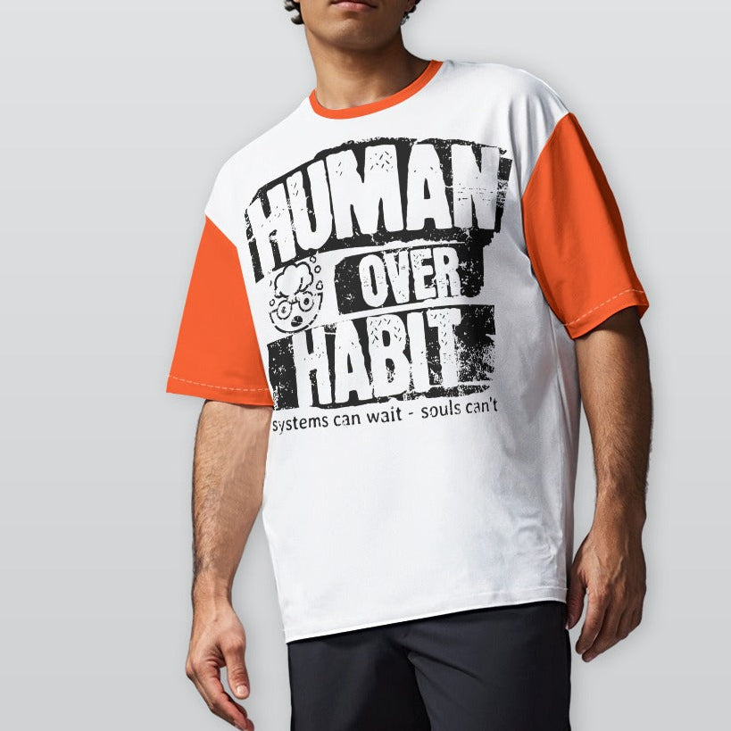 Person wearing a white and orange t-shirt with 'Human Over Habit' text on a plain background